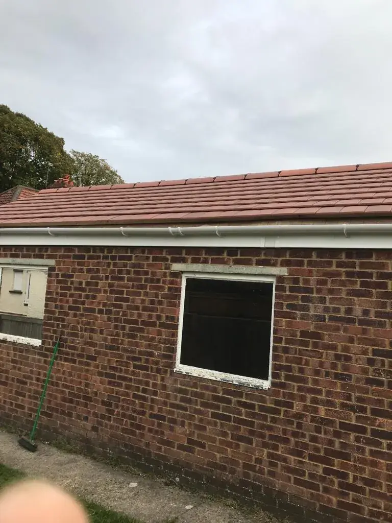 Roof tile completion and brick wall by BBBrotherBuilding in Hertfordshire