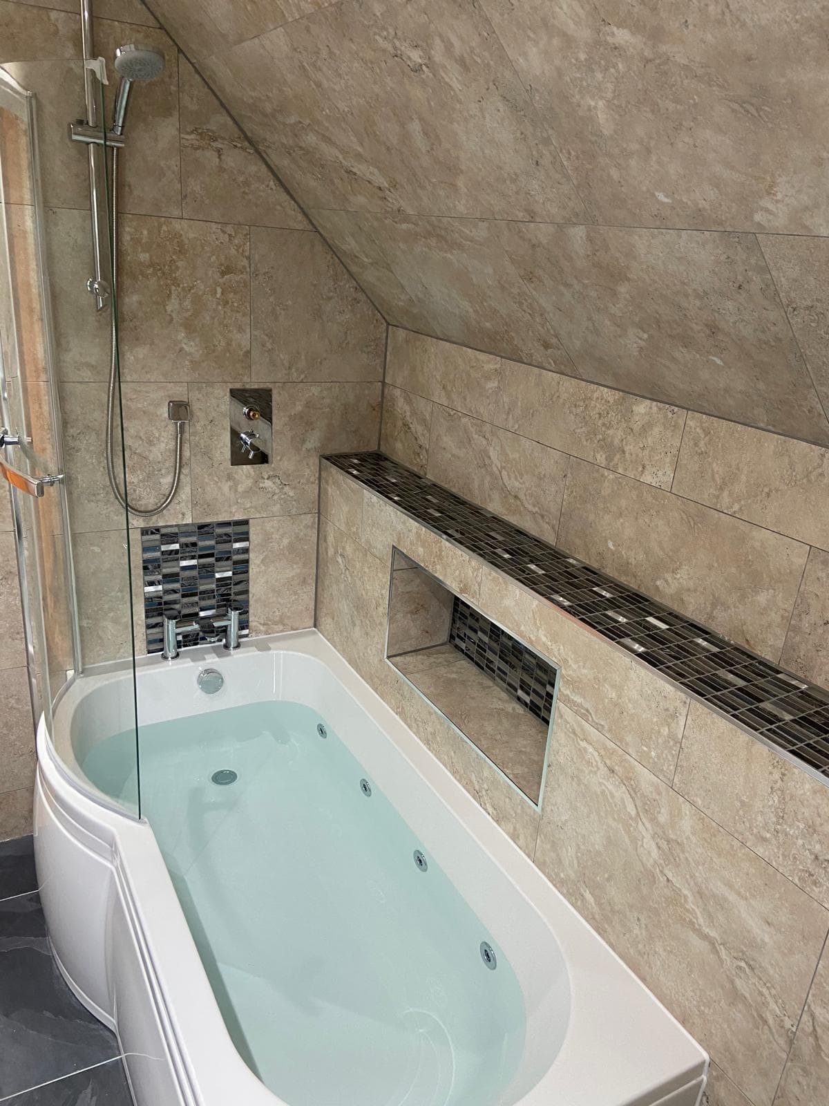 Completed bathroom renovation with tub, shower and tiling