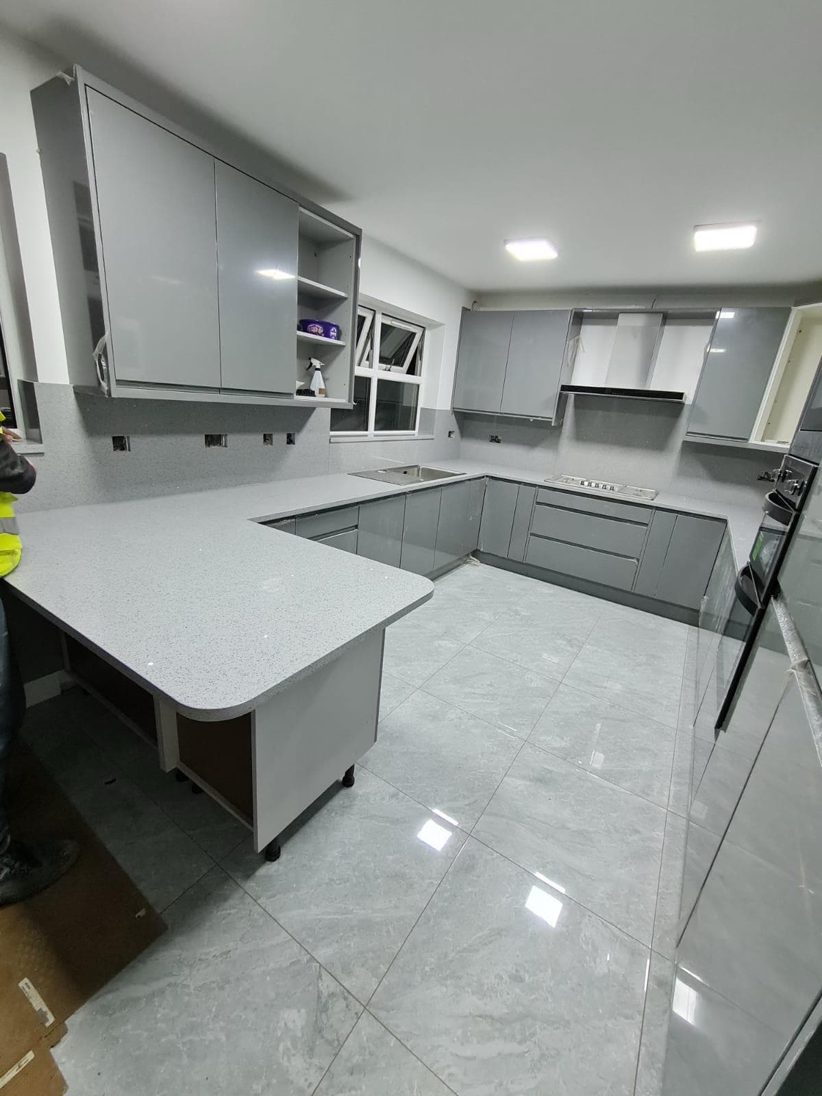 Completed kitchen fitting with grey cabinets by BBBrotherBuilding in Hertfordshire